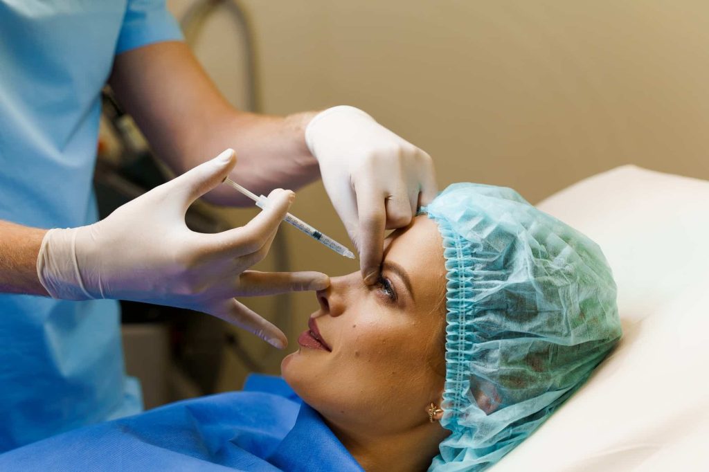 A lady having her non surgical nose job injection. 